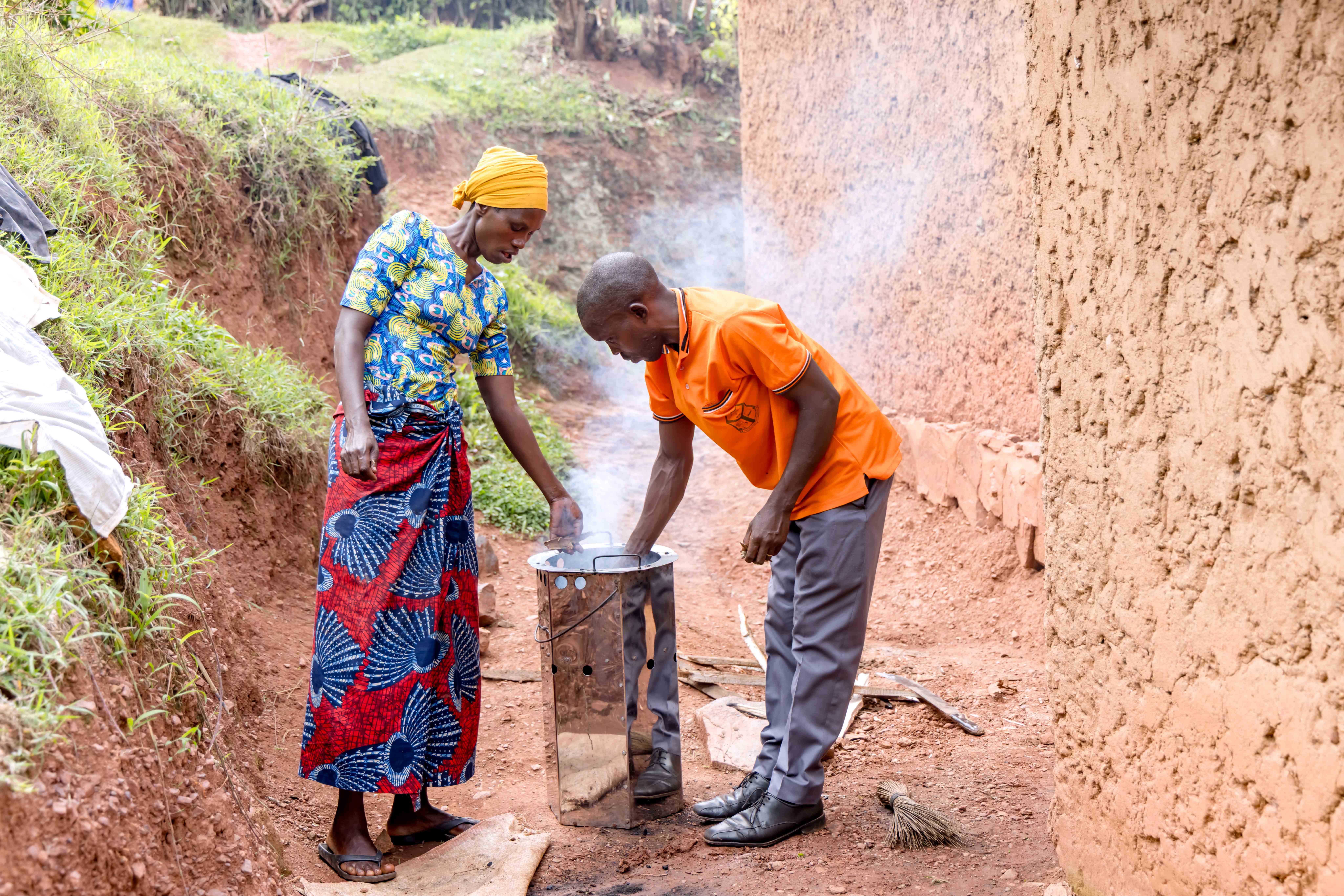 Emmanuel and Vestine preparing their improved fuel-efficient stove, a tool that has reduced firewood use and eased daily cooking. Photo: FAO Rwanda/ Christian Ngabonziza