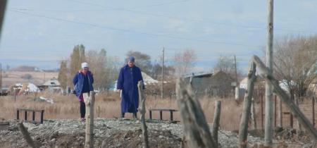 Two women walk along a path