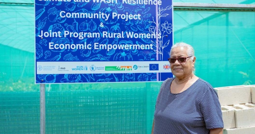 Anaika in front of the Green House with the JP RWEE sign. Photo: Morgan Puli'uvea/JP RWEE Tonga